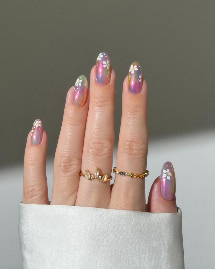 Blue metallic gold flower nail art - elegant hand showcasing blue base with metallic gold flower petals, featuring green leaves and stems on almond-shaped nails